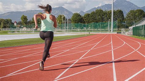 Athlete Woman Sprinting From A Three Point Start Position Stock Photo
