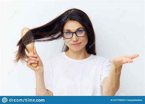 Portrait Of A Funny Beautiful Brunette Combing Her Beautiful Long Hair