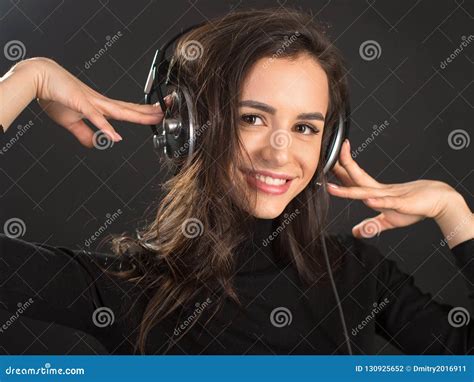 Dj Girl In Earphones Listening Disco Beats Posing In Studio Over Dark