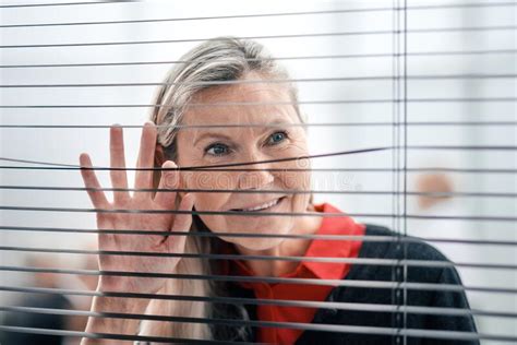 Senior Business Woman Looking Through Office Blinds Stock Photo Image