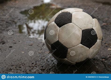 Dirty Soccer Ball Near Puddle On Ground Closeup Stock Photo Image Of