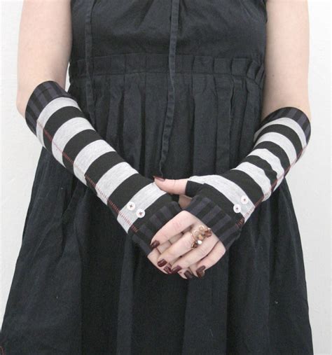 black and grey striped fingerless gloves with white buttons