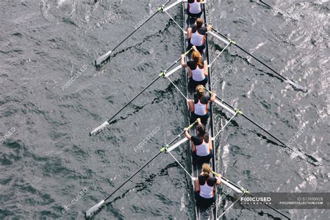 Overhead View Of Female Crew Racers Rowing In An Octuple Racing Shell