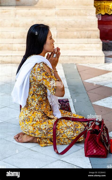 A Young Buddhist Woman Praying At The Shwedagon Pagoda Yangon Myanmar