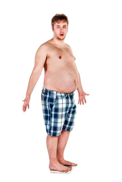 Premium Photo Overweight Fat Man Weighing Himself On Scales
