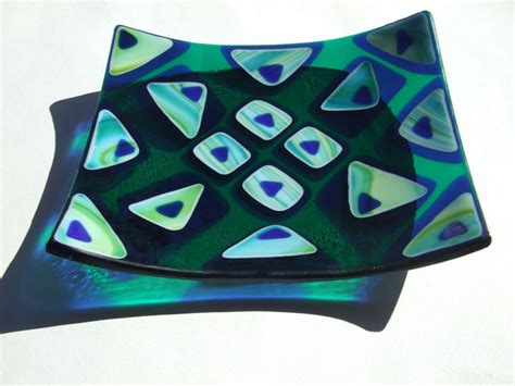 A Blue And Green Glass Plate Sitting On Top Of A Table