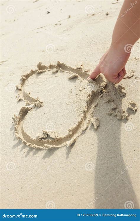 woman`s finger drawn heart shape on the sand stock image image of heart love 125206659