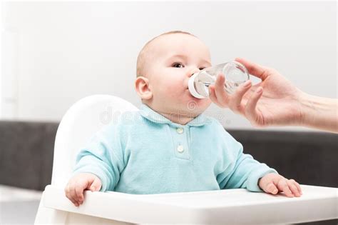 Mother Giving Baby To Drink Water From Bottle Stock Photo Image Of