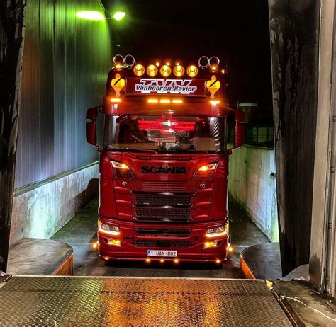 A Large Red Truck Is Parked In A Tunnel With Lights On Its Sides