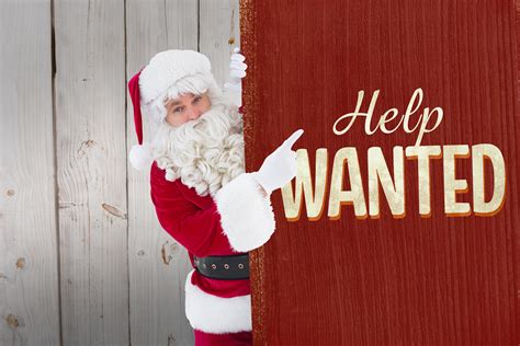 Smiling Santa Claus Pointing Poster Against Vintage Help Wanted