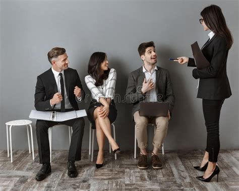 Businesswoman Choosing One Of Colleagues For Job Interview On Sits