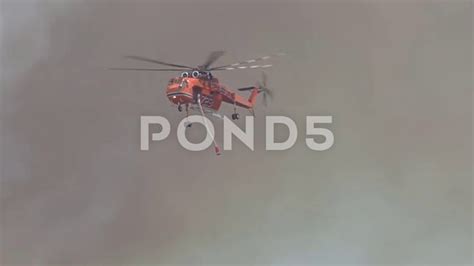 Helicopter Extinguishes Fire By Throwing Tons Of Water On Fire Stock