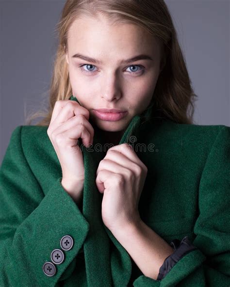 Gorgeous Stylish Blonde Model Posing In Long Luxurious Green Trench