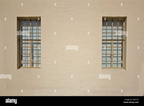 Two Multi Paned Windows On A Beige Stucco Wall Stock Photo Alamy
