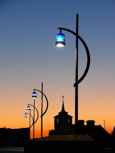 Street Lights Are Lit Up In The Evening Sky