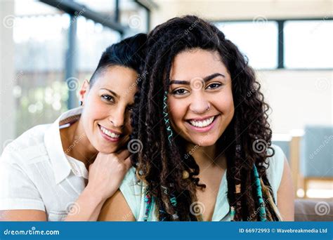 Smiling Lesbian Couple Relaxing On Sofa Stock Image Image Of Casual