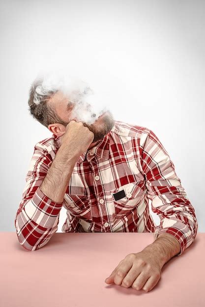 Free Photo Handsome Hipster Man Smoking Cigarette At Home