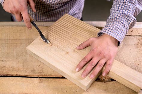 Carpenter Hands At Work Making Grooves On Wood Cutting Board Surface