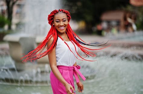 premium photo fashionable african american girl at pink pants and red dreads posed outdoor