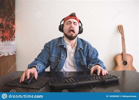 Sad Man Plays A Video Game At Home Behind A Computer In A Cozy Room
