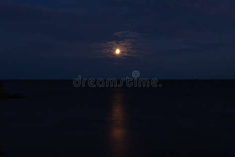 Full Moon In The Clouds Over A Calm Lake Beautiful Moon Path On The