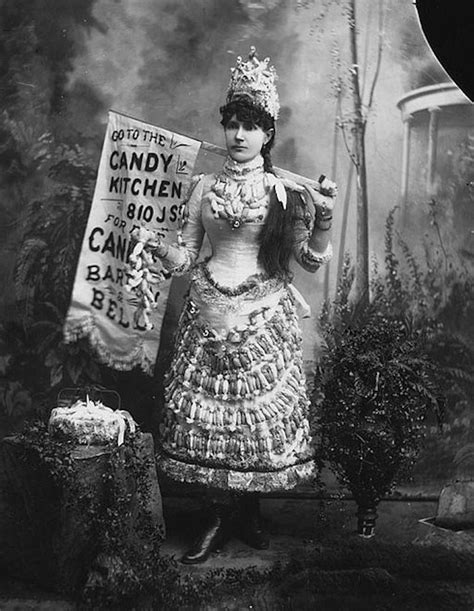 An Old Black And White Photo Of A Woman Holding A Sign