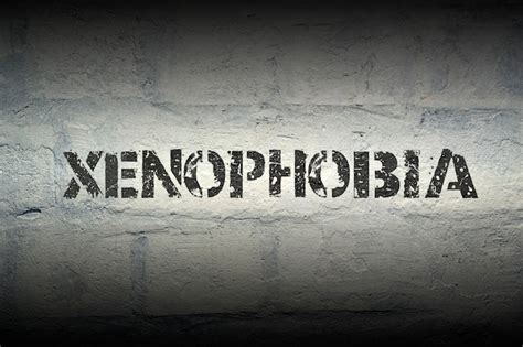 Premium Photo Xenophobia Stencil Print On The Grunge White Brick Wall