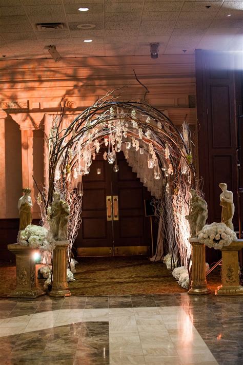 Entrance Adorned With Draping Flowers And A Rustic Archbring The