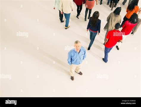 Crowd Walking Away From Man Stock Photo Alamy