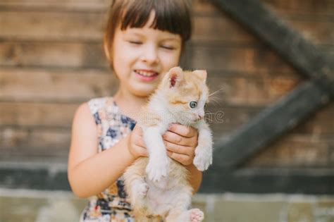 Cheerful Little Girl Holding A Cat In Her Arms Stock Image Image Of