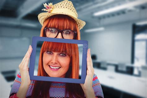 Composite Image Of Attractive Hipster Woman Behind A Tablet Stock Photo
