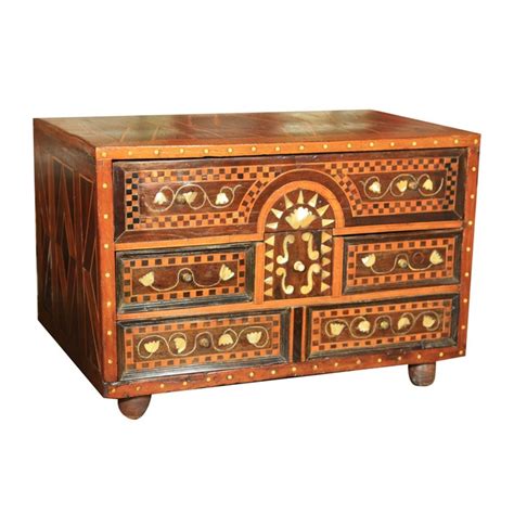 An Old Wooden Chest With Decorative Carvings On It