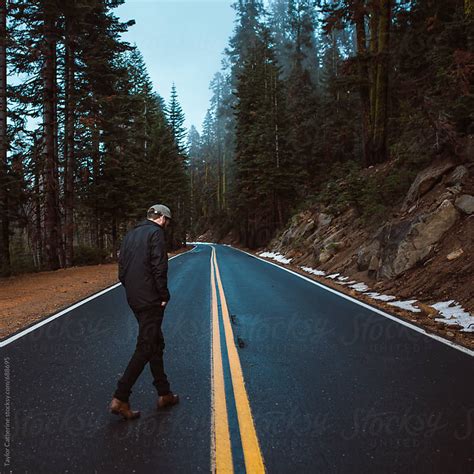 Young Man Walking Down A Mountain Road By Isaiah And Taylor Photography