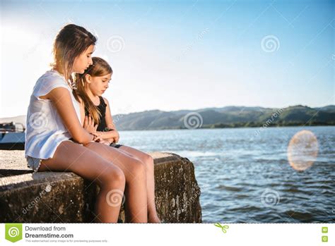 Girl Comforting Her Sad Friend On Dock Stock Image Image Of Despair