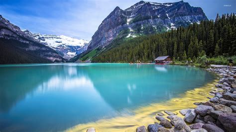 Amazing Turquoise Water Lake Guarded By Rocky Mountains Wallpaper