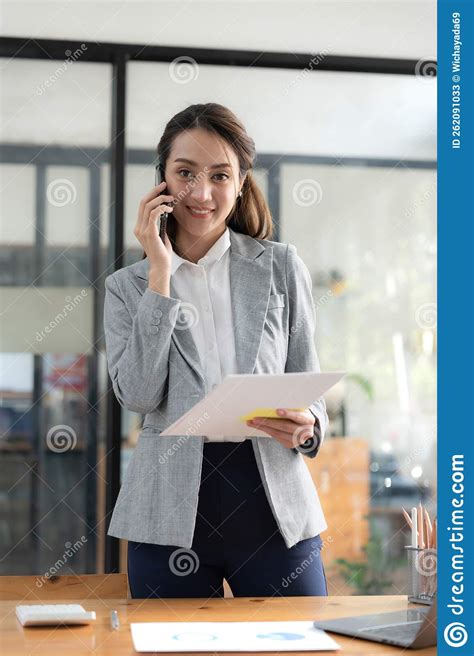 Happy Young Asian Business Woman Wearing Suit Holding Mobile Phone