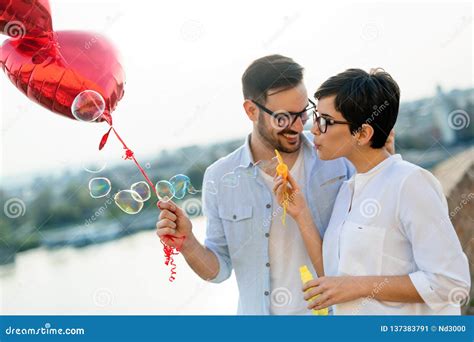 Happy Couple Dating And Smiling While Blowing Bubbles Stock Image Image Of Pretty Romance