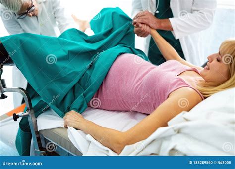 In The Hospital Woman In Labor Pushes To Give Birth Obstetricians