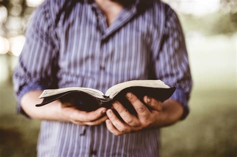 Free Photo Closeup Shot Of A Male Holding An Open Bible With A