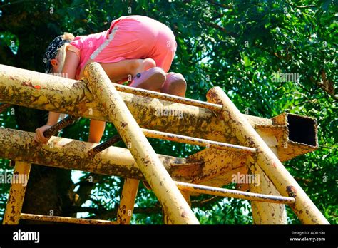 Cute Little Girl Child Climbing On A Jungle Gym At The Playground Stock