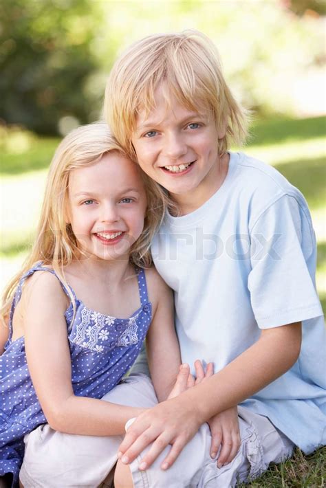brother and sister pose in a park stock image colourbox