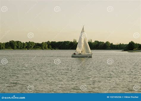Sailing Boat On A Calm Lake With Reflection In The Water Serene Scene