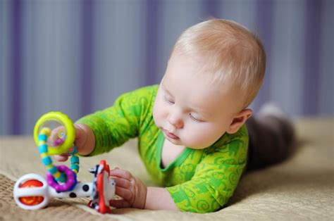 Premium Photo Six Month Old Baby Play With Bright Toys