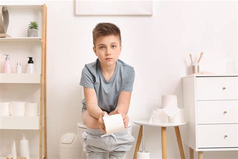 Little Boy Sitting On Toilet Bowl In Restroom Kontinensforeningen