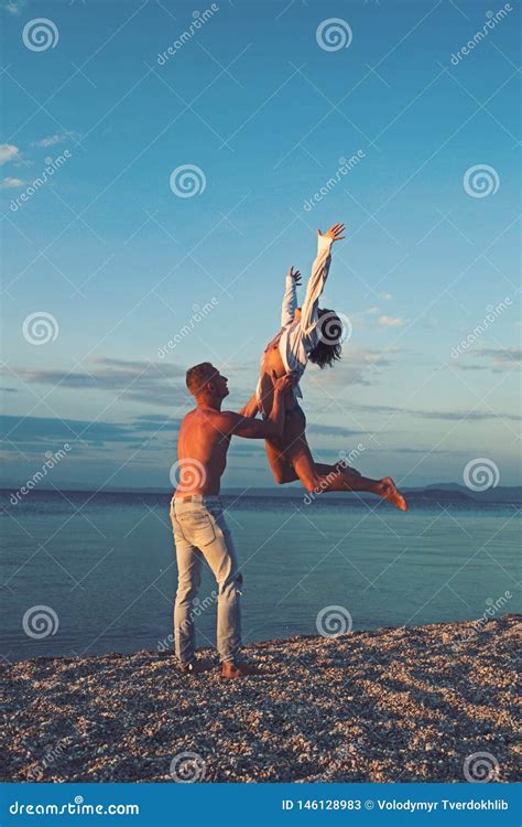 Woman And Man Jump On Sand Happy Family On Valentines Day Love Relations Of Naked Couple At