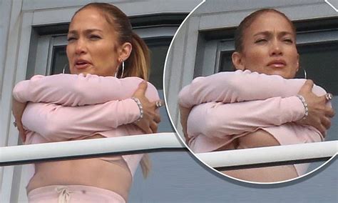 jennifer lopez flashes her toned midriff and major underboob in pink crop on hotel balcony in
