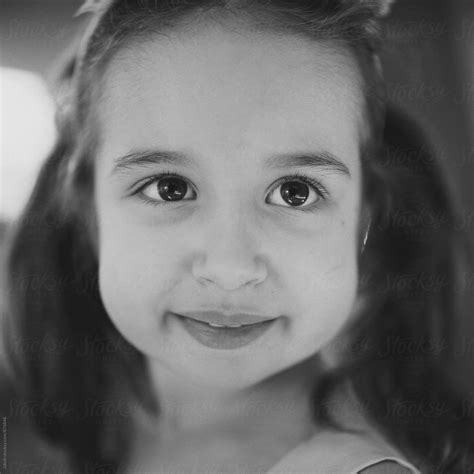 Black And White Close Up Portrait Of A Beautiful Young Girl With Big Cheeks By Stocksy
