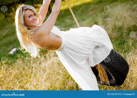 Blonde Girl On Rope Tire Swing Farmgirl Or Cowgirl Stock Image Image