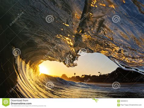Ocean Wave Tube At Sunset On The Beach In California Stock Photo