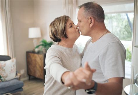 Your Kisses Let Me Know That I Am Home A Mature Couple Slow Dancing In Their Lounge Stock